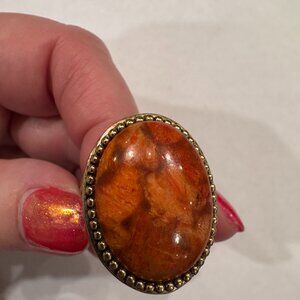 Striking oval gold-tone orange ring